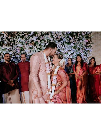 A tender kiss on the forehead, a gesture of love and blessing from the groom to his bride.