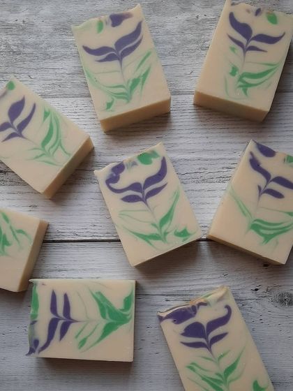 My Blooming Lavender soap, laid out to show the delicate feather swirl design. Each bar is a unique piece of art, scented with a calming blend of lavender and citrus essential oils.