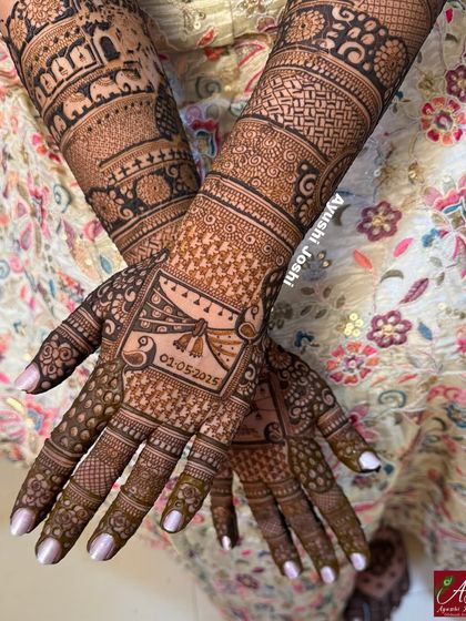 A close-up of the back of the hands, showing the detailed Gathbandhan knot and the wedding date.