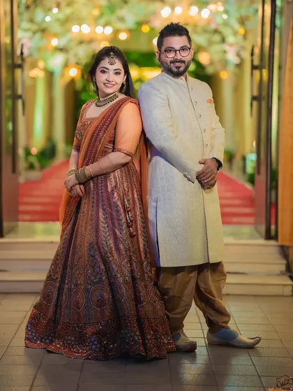 A stylish, full-length portrait of Rohan and Pooja. The back-to-back pose is modern and confident, showcasing their individual style.