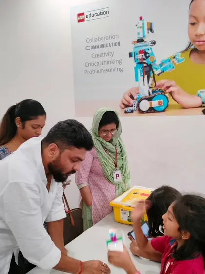 A student at Vidyashilp Academy enthusiastically explains her project to her parents. Our programs build the confidence to present and share ideas.