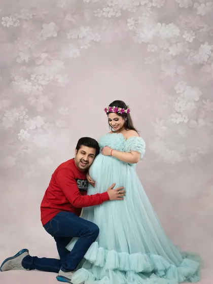 The dad-to-be listens in, sharing a special moment with his baby. This is a classic and heartwarming pose for any maternity couple photography session, full of love and wonder.