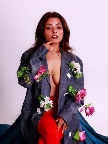 A confident and engaging pose. This portrait is a celebration of creativity, nature, and bold self-expression.