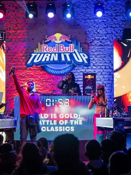 On stage for the Red Bull 'Turn It Up' event. A classic DJ battle setup with multiple artists ready to rock the crowd.