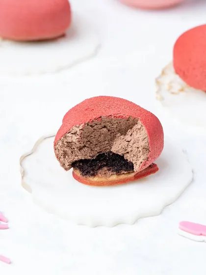 The same petit gateau cut open to reveal the rich mousse filling. Showing the inside of a dessert is a key technique to make it look more tempting.