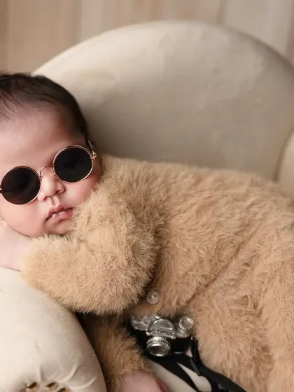 Our little boy has all the swag for you. Posed with a vintage camera, this little photographer is ready for his close up.
