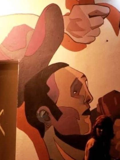 A close-up of the comic book style mural we painted for KA43 Cafe. The warm lighting highlights the bold outlines and character expressions in this custom wall painting.