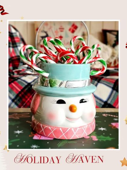 A festive snowman mug filled with candy canes, representing the cozy holiday drinks available at my café. I often run special offers like 'Buy 1 Get 1 Free' on hot chocolate during the season.