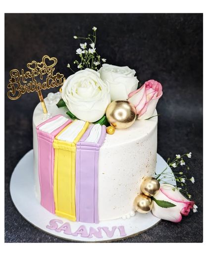 Another beautiful book-themed cake, this time with a butterscotch caramel flavor. It's decorated with fresh roses and fondant books for an elegant look.