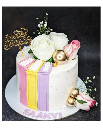 Another beautiful book-themed cake, this time with a butterscotch caramel flavor. It's decorated with fresh roses and fondant books for an elegant look.