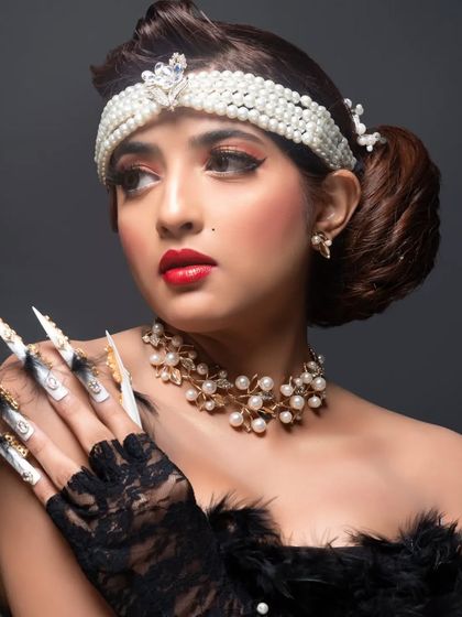 A full view of the retro-inspired fantasy nails, showcasing their dramatic length and the combination of hand-painted art, feathers, and embellishments.