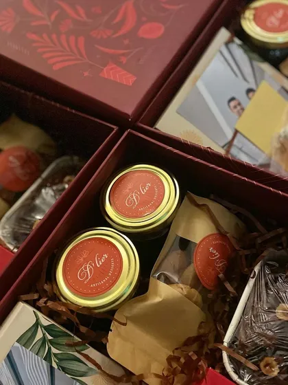 A custom engagement announcement hamper, filled with an assortment of our finest desserts, a personalized photo, and decorative elements to celebrate the happy couple.