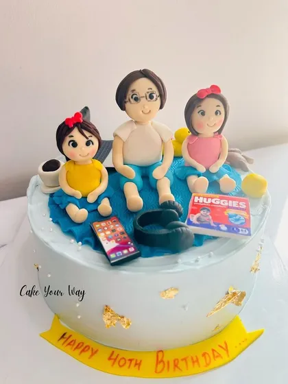 A cake celebrating family and turning 40, with custom fondant figures.