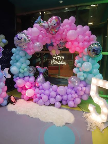 Another perspective of the mermaid balloon arch, showing the light-up "5" and the way the decorations frame the party space.