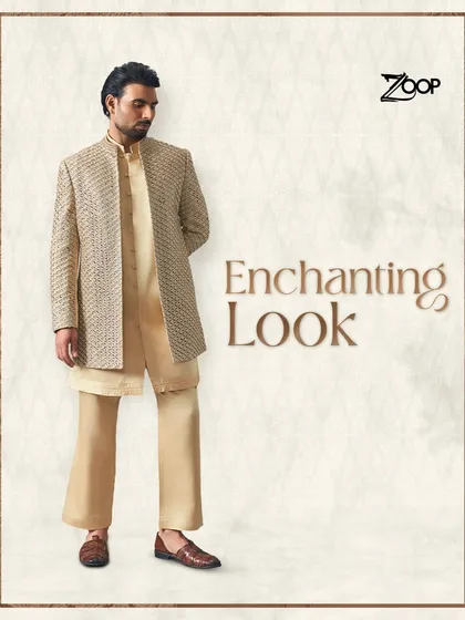An enchanting look for the wedding season. This layered beige sherwani with subtle texture is perfect for the groom who prefers understated elegance and a sophisticated silhouette.