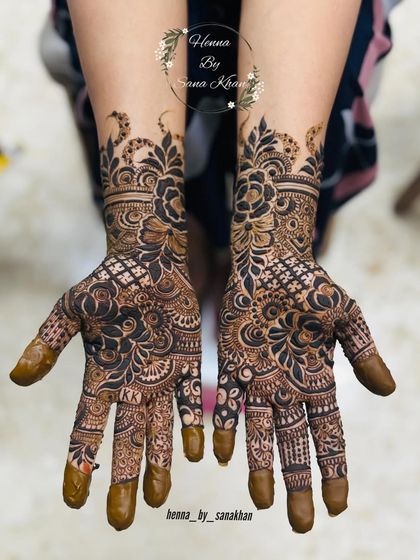 A stunning and intricate design that combines floral elements with paisley patterns, covering the hands in beautiful detail.