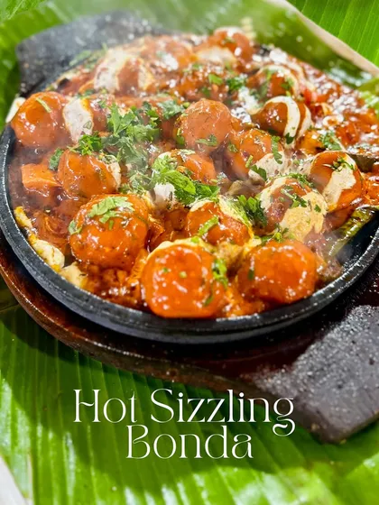 For those who like it hot, I created the Hot Sizzling Bonda. These classic potato bondas are tossed in a spicy peri peri sauce and served on a sizzling platter, filling the air with an amazing aroma.