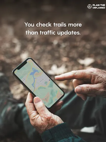 A trekker checking a trail map on their phone. This reflects the mindset of our community: you check trails more than traffic updates.