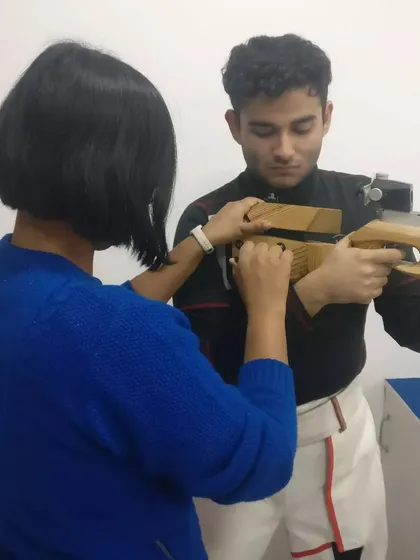 Our Junior Coach and National Shooter, Sapna Kumari, provides one-on-one guidance to a promising rifle shooter. This mentorship is crucial for developing competitive athletes.