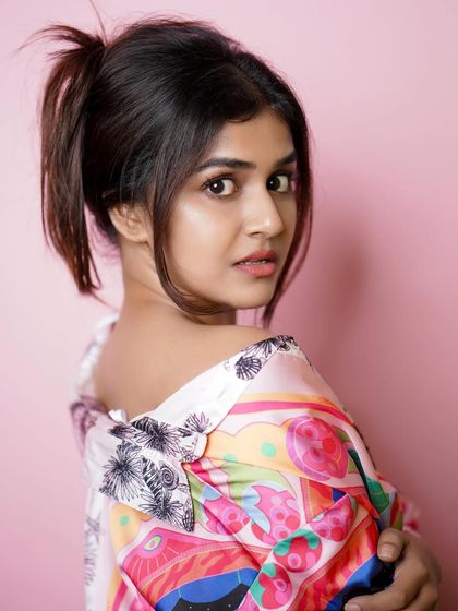 A close-up portrait with a fun, quirky expression, showing the model's personality.