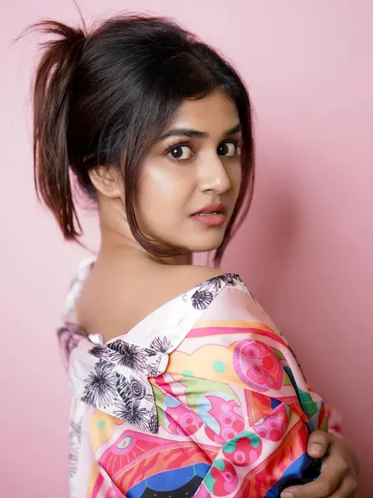 A close-up portrait with a fun, quirky expression, showing the model's personality.