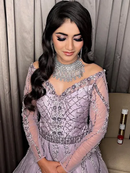 A full look at this cocktail glam style. The off-shoulder lavender gown is perfectly paired with dramatic eyes and soft, flowing hair.
