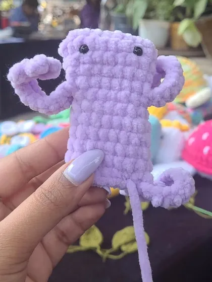A work-in-progress shot of a little purple frog I started making during a market. It's always fun to crochet on the go and show people how these toys are made.