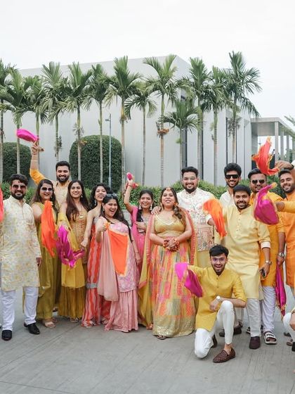 The entire bride and groom squad posing together in their yellow-themed outfits for the Haldi ceremony. A great shot of the whole team.