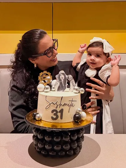 A sweet, tender moment where I'm looking at Gauri during my birthday cake cutting. It shows that even during my own celebration, she is the center of my world.