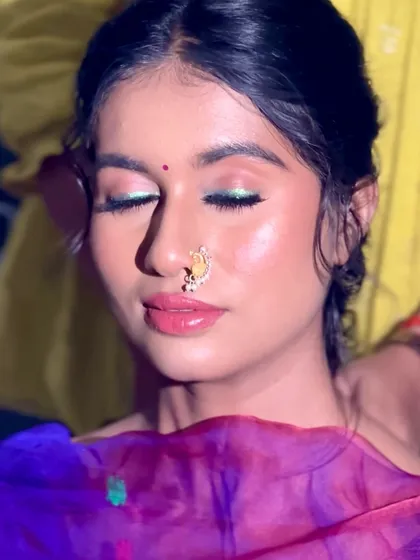 A close-up of the eye makeup for the Haldi look, featuring a pop of green liner to complement the yellow saree.