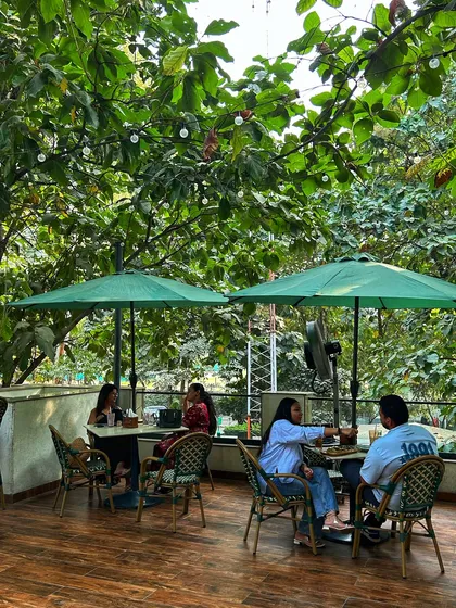 Guests enjoy a meal on the upper deck of the cafe, a prime spot for views and relaxation.