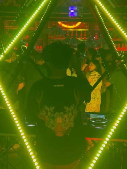 A shot of me from behind, framed by the green neon pyramid.