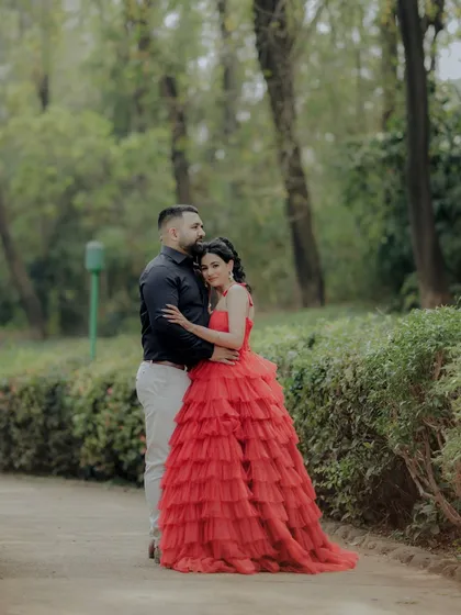 A tender moment of embrace between the couple in a beautiful Pune garden. The composition draws the eye to their connection, making it a perfect example of a romantic and cinematic engagement photo.