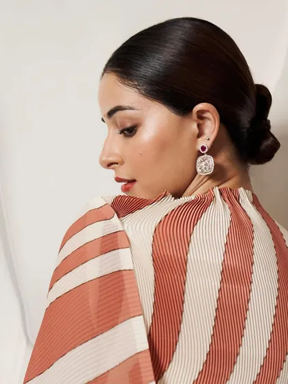 A beautiful profile of Ananya Panday, showcasing the Cherry Blossom earrings with their vibrant Mozambique rubies.