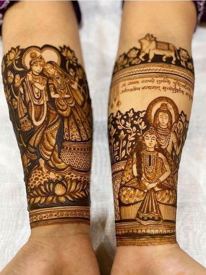 A divine bridal design featuring portraits of Radha-Krishna and Shiv-Parvati on the arms. A truly blessed beginning for the bride.