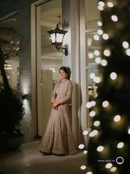 Another beautiful shot from the sangeet. The bokeh lights add a magical touch, and her makeup looks flawless and radiant.