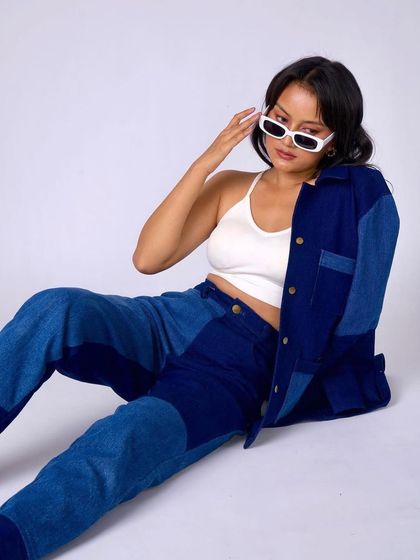 A cool, street-style look featuring a denim co-ord set. The makeup is minimal and fresh, with a simple hairstyle to match the laid-back vibe.
