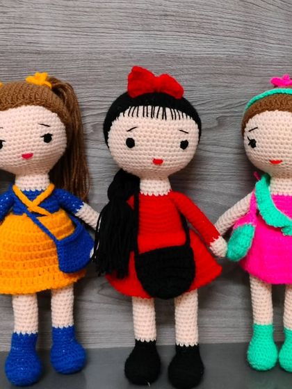 Three friends, each with their own style. One in yellow, one in red, and one in pink and green.
