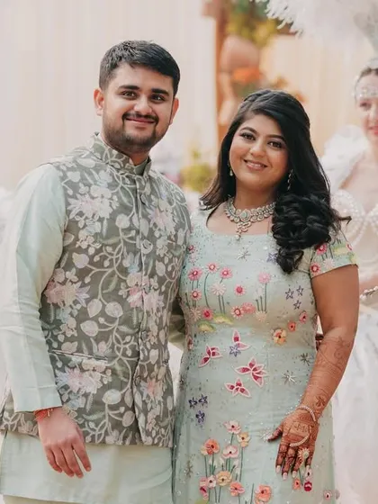 A classic portrait of the couple, their pastel outfits perfectly complementing the soft, romantic decor.