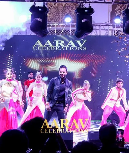 A climactic moment in a family sangeet performance, complete with a confetti blast and smoke effects. I use these production elements to create unforgettable, high-impact finales.