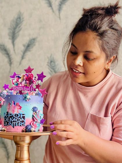 Hi, I'm Sarita, the baker and dreamer behind The Dessert Chowk. Here I am, putting the finishing touches on a K-Pop themed cake.