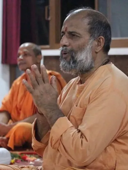Leading the chanting during satsang. The vibrations of the mantras help to purify the mind and elevate the spirit, bringing the group together in a shared state of devotion.