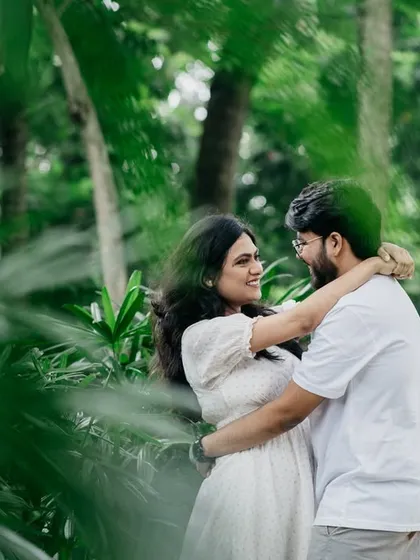 An intimate and loving embrace surrounded by the lush greenery of a Bangalore park. This shot highlights the couple's connection in a beautiful, natural setting.