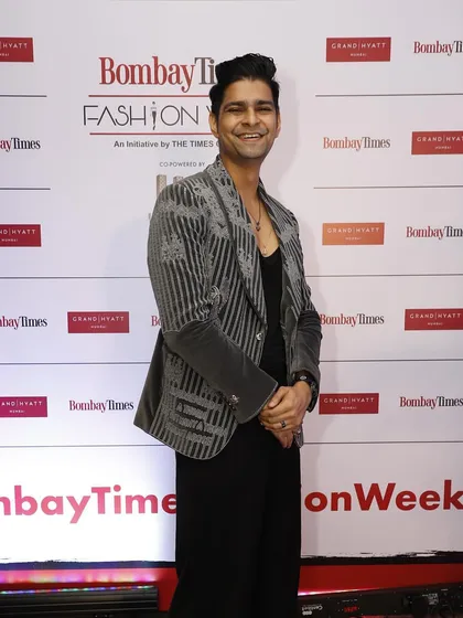 Vinay Mishra at Bombay Times Fashion Week in the same grey velvet coat. This look shows its versatility, styled here for a fashion-forward event with an all-black base to let the embroidery shine.