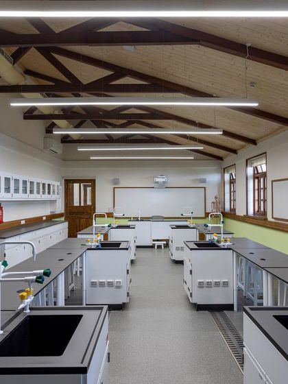 A view down the length of the new biology lab, showcasing the clean, bright design and the seamless integration of modern lab services like sinks and gas taps.