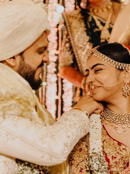 A tender moment between Nidhi and Jay during their ceremony, his gentle touch and her happy smile.