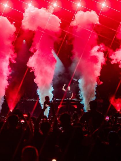 Red CO2 smoke fills the stage during Armin van Buuren's set, creating a hellish and intense atmosphere that matches the driving trance beats.