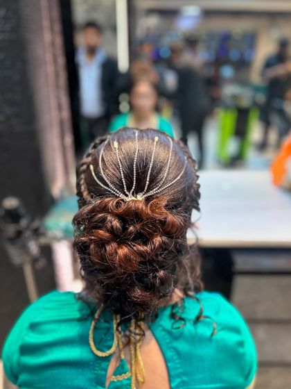 A final shot of the intricate messy bun, showcasing the texture and accessory placement.