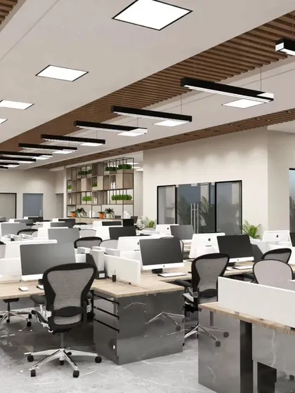 An overview of the open-plan workspace designed for our upcoming project in Bengaluru. The layout emphasizes order and efficiency, with modern ergonomic chairs and clean desk setups under a well-lit ceiling with wooden accents.