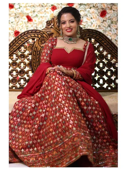 This vibrant red lehenga with intricate, all-over embroidery is a showstopper. It's a classic choice for bridal events or receptions, offering a rich, traditional look that is both timeless and elegant.